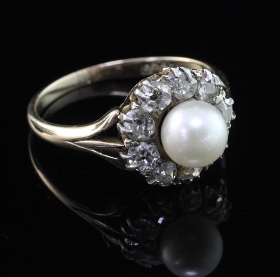 An early 20th century 15ct gold cultured pearl and diamond cluster ring, size M.